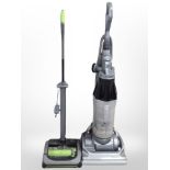 A Dyson upright vacuum cleaner and a G-Tech vacuum.