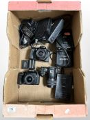 A box of digital camera bodies including Pentax K10, Canon EOS 70D, several battery packs, etc.