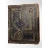 A Victorian leather-bound album of portrait photographs and postcards.