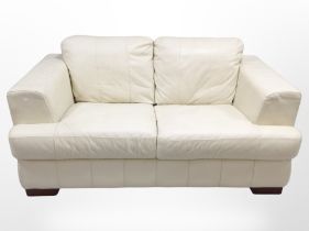 A contemporary cream leather two-seater settee, 162cm long x 95cm deep x 80cm high.