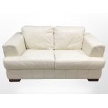 A contemporary cream leather two-seater settee, 162cm long x 95cm deep x 80cm high.