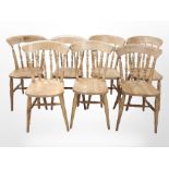 A set of seven pine spindle-back dining chairs.