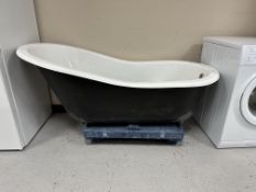 An enameled cast-iron roll-top bath with a set of four gilt metal claw and ball feet,