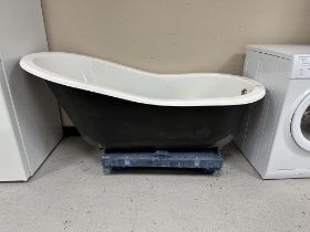 An enameled cast-iron roll-top bath with a set of four gilt metal claw and ball feet,