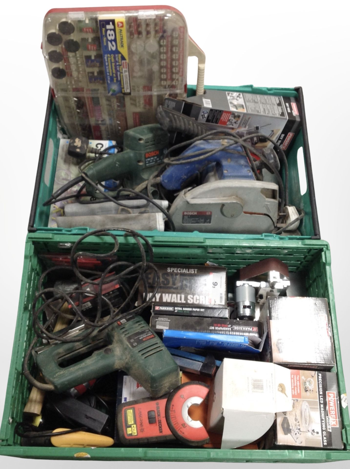 Two crates containing assorted power tools, LED magnifying glasses, rotary tool accessory set, etc.