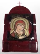 A reproduction continental icon in red glass surround, 35cm x 21cm.