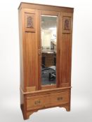An early 20th-century satinwood mirrored door wardrobe, 93cm wide x 42cm deep x 195cm high.
