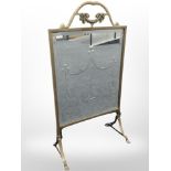 A brass and bevelled glass mirrored fire screen, height 80cm.