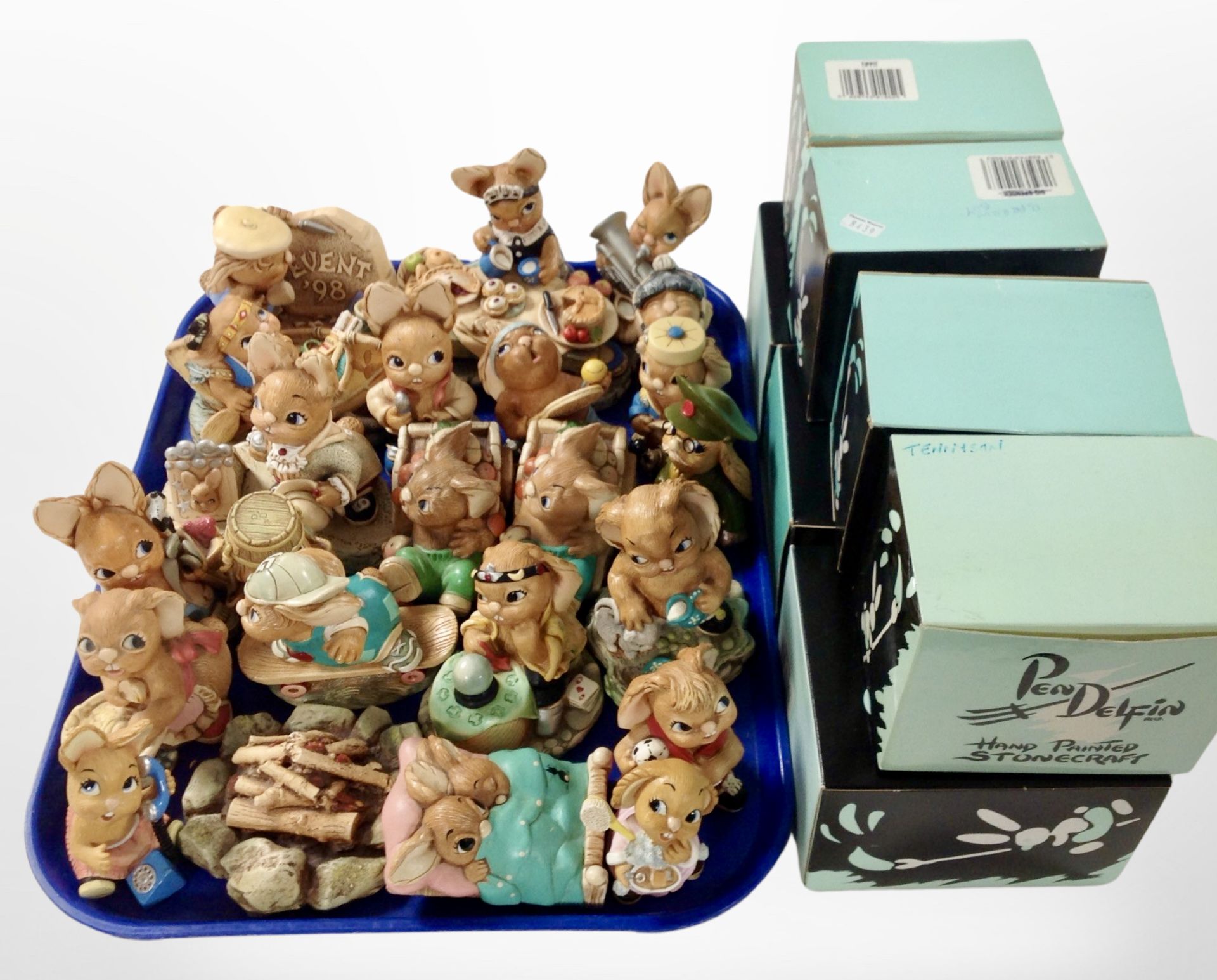 A collection of Pendelfin rabbit ornaments and seven boxes.