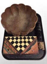 An Eastern carved wooden scalloped-edge bowl, together with a decorative chess set in box,