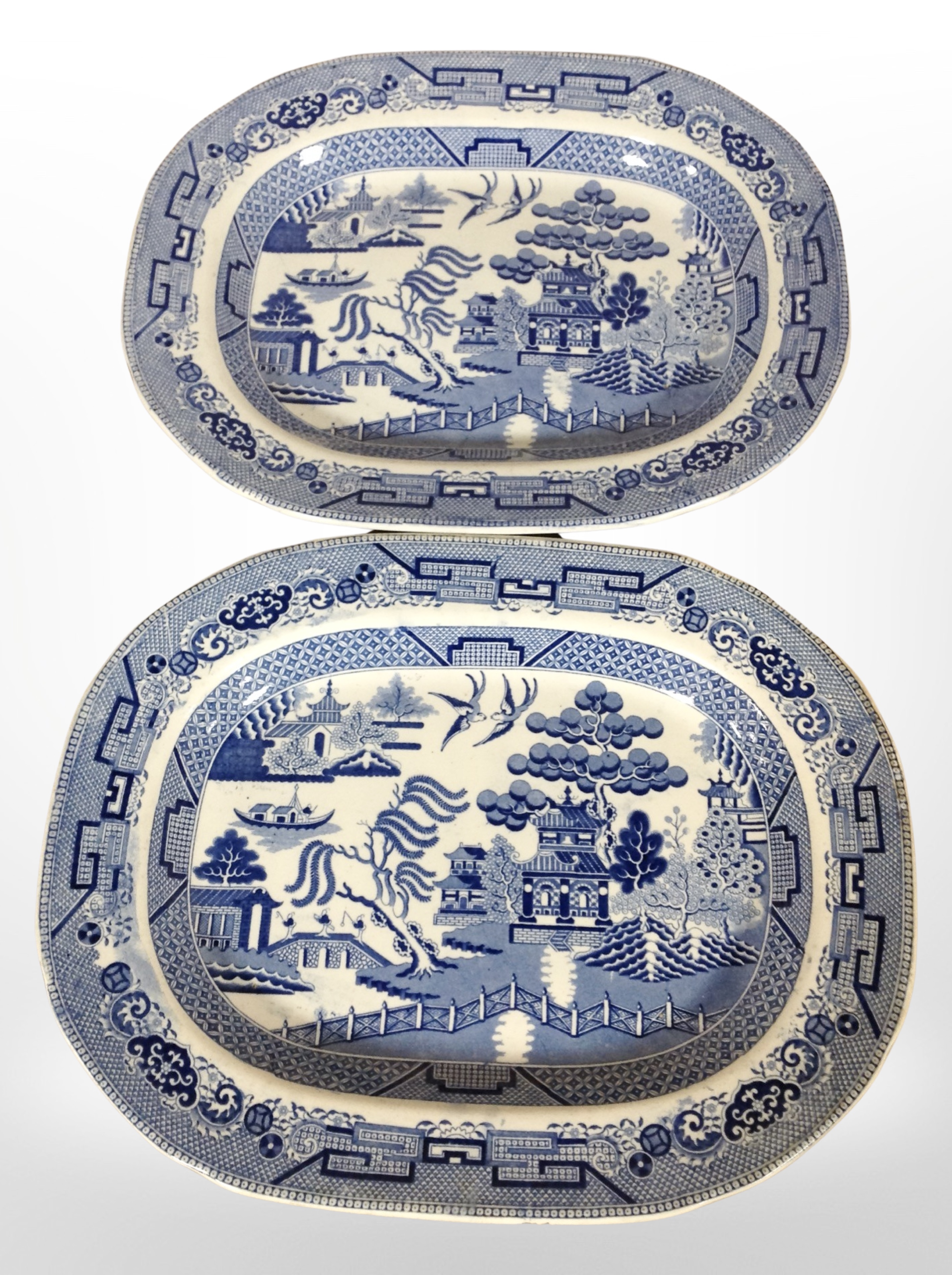 A pair of 19th-century Staffordshire blue and white willow pattern meat plates, width 40cm.