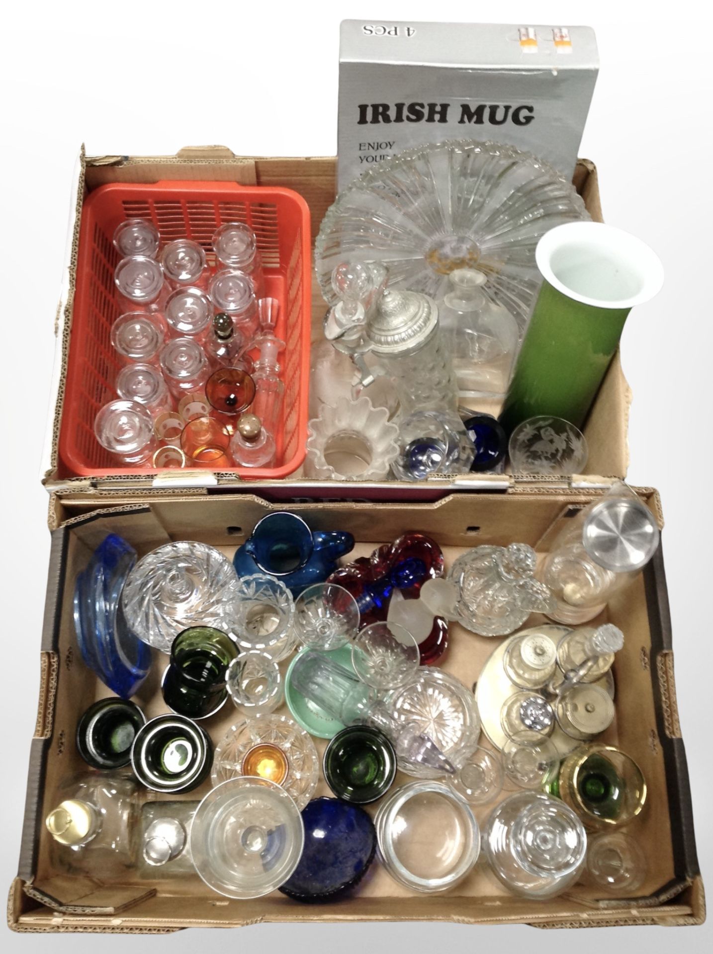 Two boxes containing 20th-century glass wares, Holmegaard bottles, drinking glasses, etc.