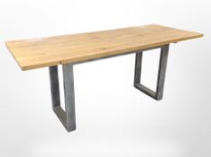 An oak-topped industrial-style table on painted metal supports, length 180cm.