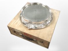 An ornate silver-plated mirrored cake stand, diameter 40cm, in pine box.