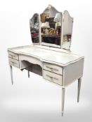 A French-style cream and gilt mirror-backed dressing table, 126cm wide x 49cm deep x 139cm high,