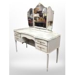 A French-style cream and gilt mirror-backed dressing table, 126cm wide x 49cm deep x 139cm high,