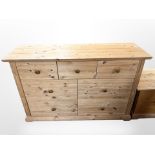 A contemporary pine seven-drawer chest, 134cm wide x 44cm deep x 85cm high.