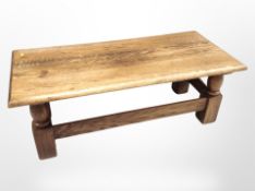 A reproduction oak refectory coffee table, 131cm long x 60cm wide x 46cm high.