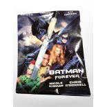 A group of rolled movie posters including Batman, etc.