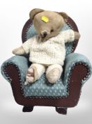 A vintage teddy bear with armchair, chair 37cm high.