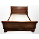 A reproduction mahogany 4' 6" sleigh bed, 222cm long x 147cm wide x 96cm high.