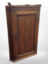 A George III oak and satinwood-inlaid hanging corner cabinet, height 106cm.