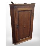 A George III oak and satinwood-inlaid hanging corner cabinet, height 106cm.