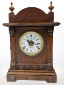 An oak-cased eight-day mantel clock retailed by Fattorini & Sons of Bradford, height 43cm.