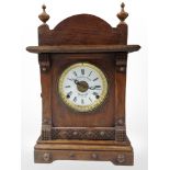 An oak-cased eight-day mantel clock retailed by Fattorini & Sons of Bradford, height 43cm.