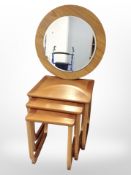 A teak nest of three tables and a further circular mirror.