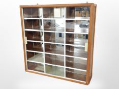 A glazed pine wall-mounted display case, 63cm x 63cm.