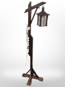 An oak standard lamp with lantern shade, height 148cm.