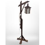 An oak standard lamp with lantern shade, height 148cm.