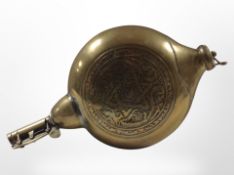 An Islamic brass moon-shaped powder flask, length 25cm.