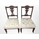 A pair of late Victorian mahogany salon chairs with embroidered seats.