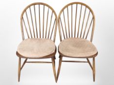 A pair of Ercol stained elm spindle-back dining chairs.