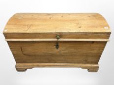 A 19th century pine dome topped trunk with cast iron handles,