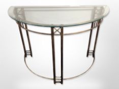 A metal and glass demi-lune console table,