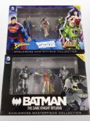 Two Eaglemoss Masterpiece Collection figurine sets, Batman, Superman, Wonder Woman and Lex Luthor.