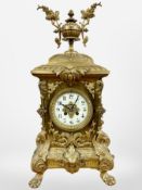 An impressive 19th century gilt metal eight day mantel clock, raised on lion paw feet,