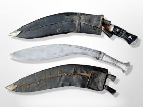 Two kukri knives in sheathes, one with aluminium grip, longest 44cm.