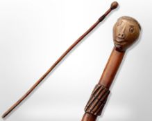 An early 20th-century South African chief's carved hardwood staff with figural pommel, length 90cm.