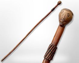 An early 20th-century South African chief's carved hardwood staff with figural pommel, length 90cm.