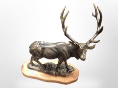 A cast-iron stag on wooden plinth, height 46cm.