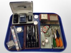 A group of vintage darts, travel timepiece, precision drawing set, Crowns,