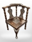 A 19th century carved oak corner armchair