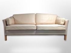 A contemporary Scandinavian cream leather three seater settee,