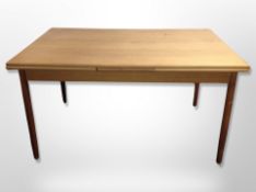 A Danish teak extending pull-out dining table,