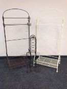 Two wrought metal towel rails and a further bottle stand,