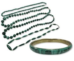 A malachite bangle and four similar polished bead necklaces